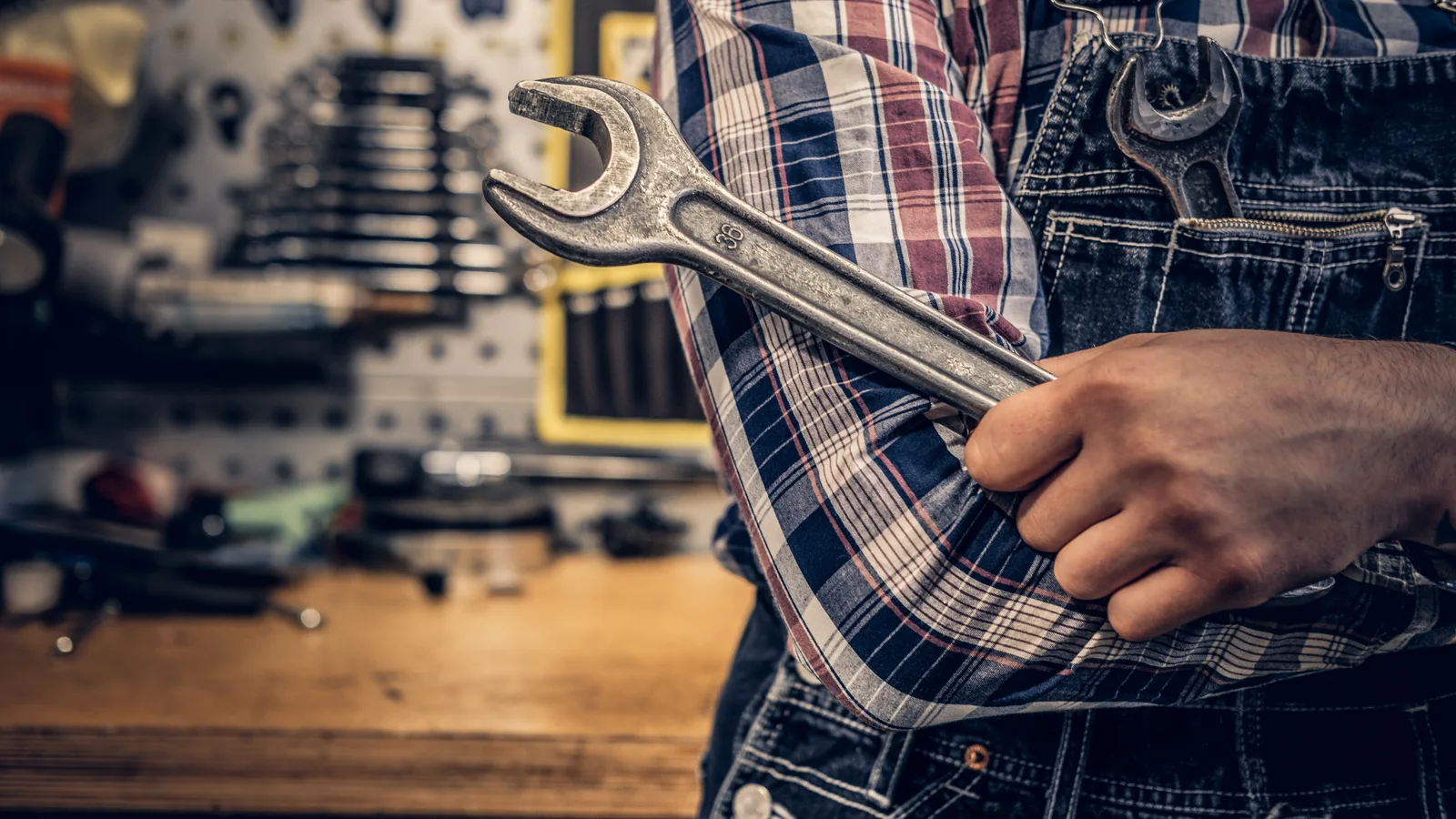 Close-up of a mechanic's arm using a wrench on a nut at the Baywrex workshop in Bayswater North
